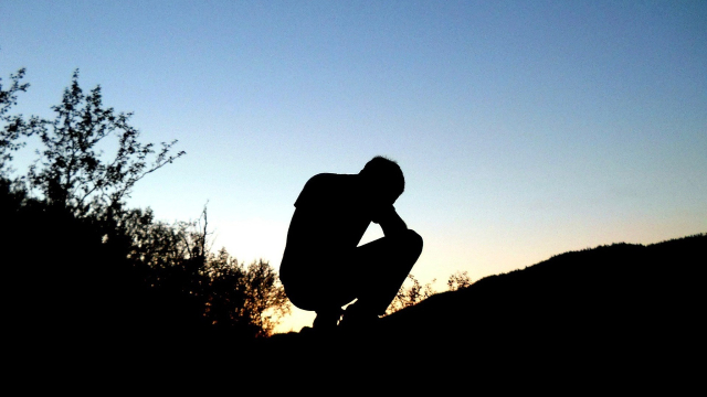 man_crouching_silhouette