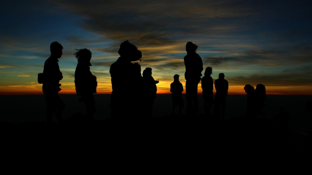people_silhouettes_hill_sky
