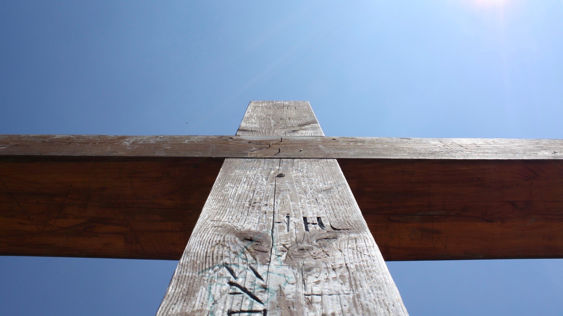 Looking upwards at a wooden cross