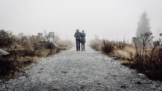 couple_walking_rocky_path_desolate