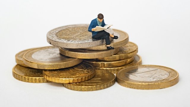 figure_sitting_on_coins_unsplash