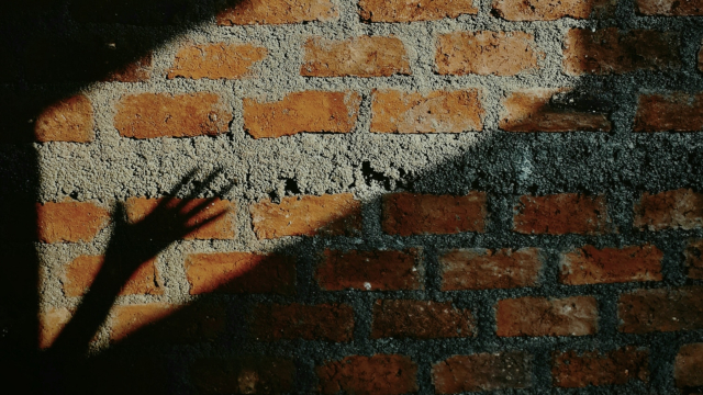 hand_shadow_sun_brick_wall_unsplash
