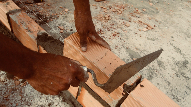 hands_laying_bricks