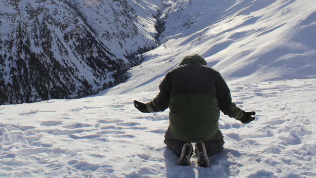 kneeling_man_snow_mountain_unsplash