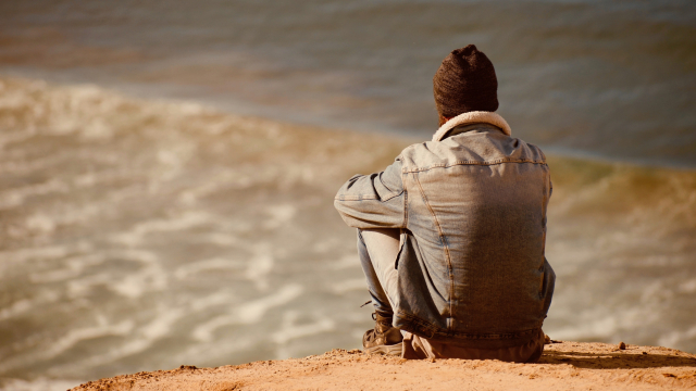 man_sitting_beach_unsplash