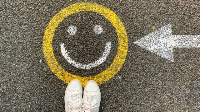 smiley_face_road_arrow_feet_unsplash