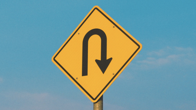 u_turn_sign_yellow_sky_unsplash
