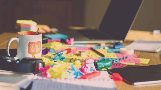 untidy_desk_laptop_sticky_notes_unsplash