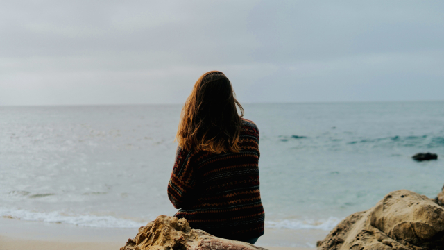 woman_sitting_rock_sea_unsplash